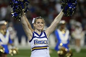 A high school football cheerleader smiling