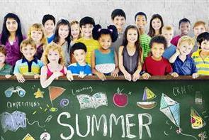 Children posing for a photo with summer camp sign