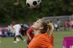 Teen heading a soccer ball.